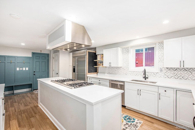 10048 King Rd, Davisburg, MI 48350 - kitchen featuring stainless steel appliances, ventilation hood, a sink, backsplash, and recessed lighting
