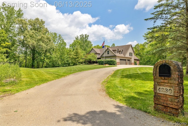 4230 Mill Lake Rd, Lake Orion, MI 48360 - view of front facade with a garage, a front lawn, and asphalt driveway