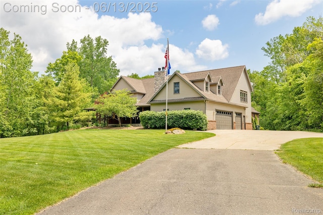 4230 Mill Lake Rd, Lake Orion, MI 48360 - view of front facade with concrete driveway, a front yard, a garage, a chimney, and brick siding
