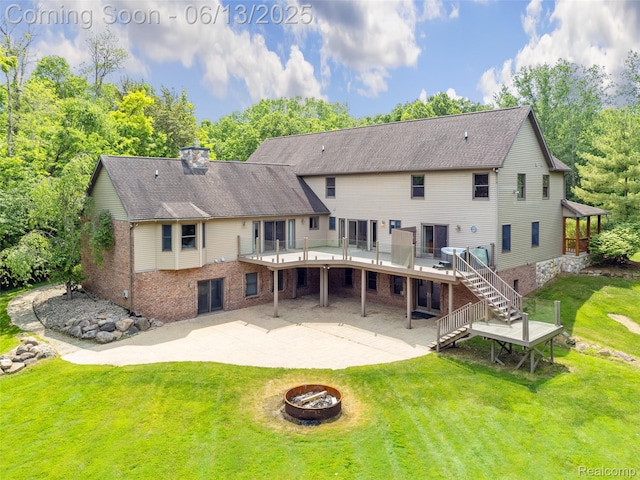 4230 Mill Lake Rd, Lake Orion, MI 48360 - back of property with a fire pit, a patio, stairs, a deck, and a yard