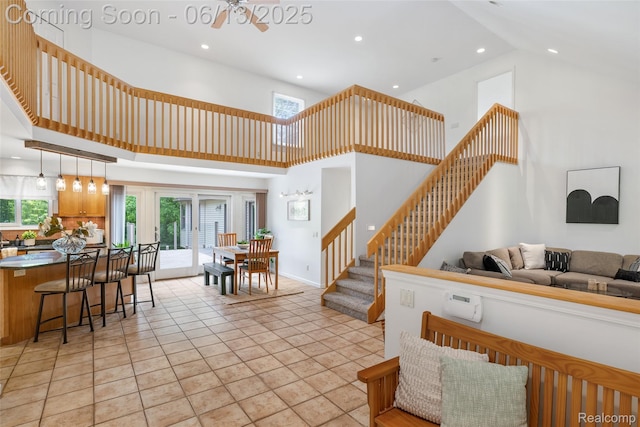 4230 Mill Lake Rd, Lake Orion, MI 48360 - living area with stairs, high vaulted ceiling, healthy amount of natural light, and recessed lighting