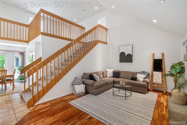 4230 Mill Lake Rd, Lake Orion, MI 48360 - living room featuring high vaulted ceiling, stairs, recessed lighting, and wood finished floors