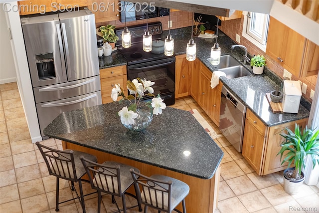 4230 Mill Lake Rd, Lake Orion, MI 48360 - kitchen with stainless steel appliances, dark stone countertops, and a kitchen breakfast bar