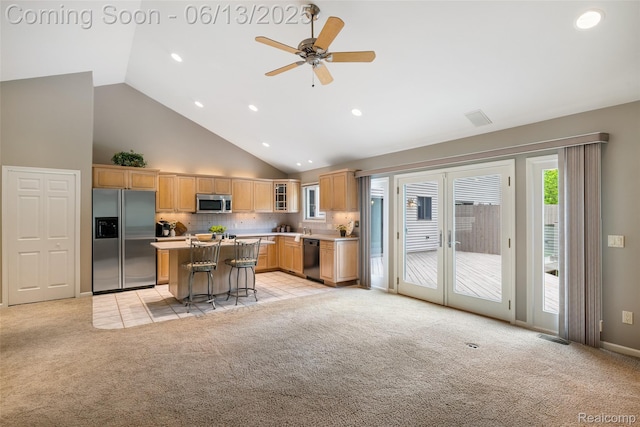 4230 Mill Lake Rd, Lake Orion, MI 48360 - kitchen with stainless steel appliances, light colored carpet, a kitchen breakfast bar, light countertops, and high vaulted ceiling