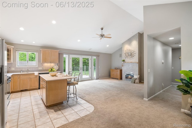 4230 Mill Lake Rd, Lake Orion, MI 48360 - kitchen featuring light brown cabinetry, light countertops, a breakfast bar area, a center island, and open floor plan