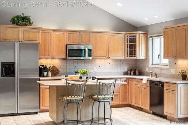 4230 Mill Lake Rd, Lake Orion, MI 48360 - kitchen with appliances with stainless steel finishes, lofted ceiling, a center island, light countertops, and light brown cabinetry