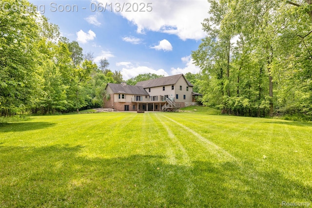 4230 Mill Lake Rd, Lake Orion, MI 48360 - view of grassy yard featuring a wooden deck and stairs