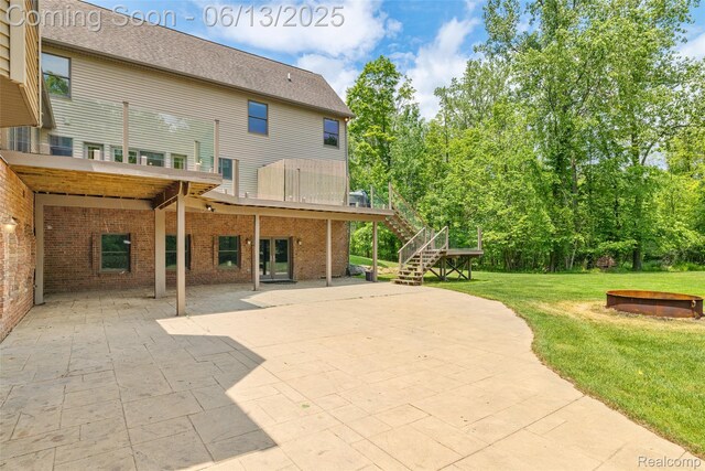4230 Mill Lake Rd, Lake Orion, MI 48360 - rear view of house with a yard, a patio area, stairs, brick siding, and a wooden deck