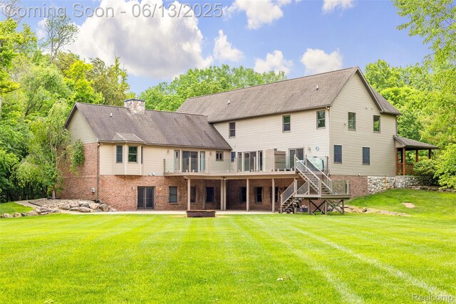 4230 Mill Lake Rd, Lake Orion, MI 48360 - back of house featuring stairway, brick siding, a chimney, a wooden deck, and a yard