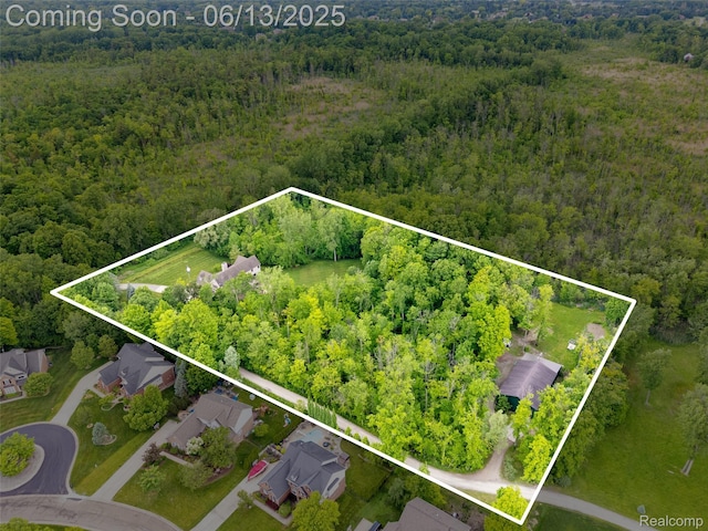 4230 Mill Lake Rd, Lake Orion, MI 48360 - aerial view of property and surrounding area featuring a heavily wooded area and property parcel outlined