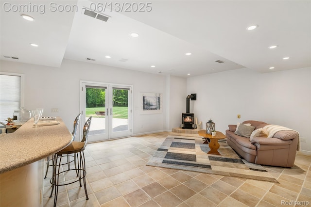 4230 Mill Lake Rd, Lake Orion, MI 48360 - living area featuring light tile patterned floors, recessed lighting, a wood stove, and french doors