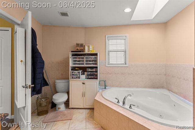 4851 Williamson St, Dearborn, MI 48126 - full bathroom with a whirlpool tub, toilet, a skylight, tile patterned flooring, and tile walls