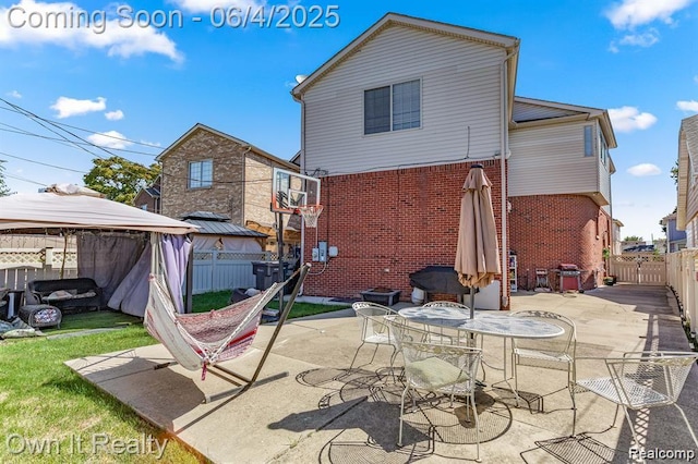 4851 Williamson St, Dearborn, MI 48126 - rear view of property featuring a gazebo, brick siding, a fenced backyard, and a patio