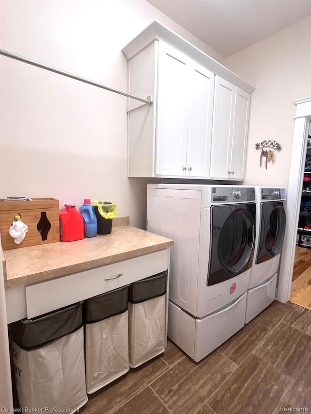 4264 W Benjamin Rd, Perry, MI 48872 - washroom featuring cabinet space, washer and dryer, and dark wood finished floors