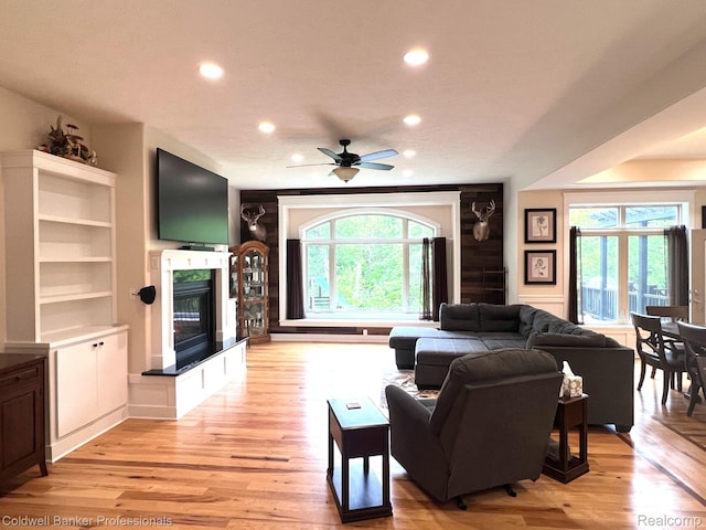 4264 W Benjamin Rd, Perry, MI 48872 - living room featuring a glass covered fireplace, light wood finished floors, recessed lighting, and ceiling fan