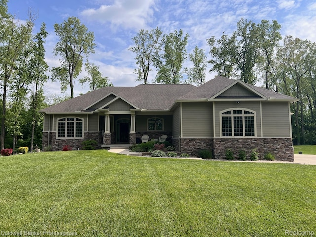 4264 W Benjamin Rd, Perry, MI 48872 - craftsman-style house featuring stone siding, a front yard, roof with shingles, and a porch