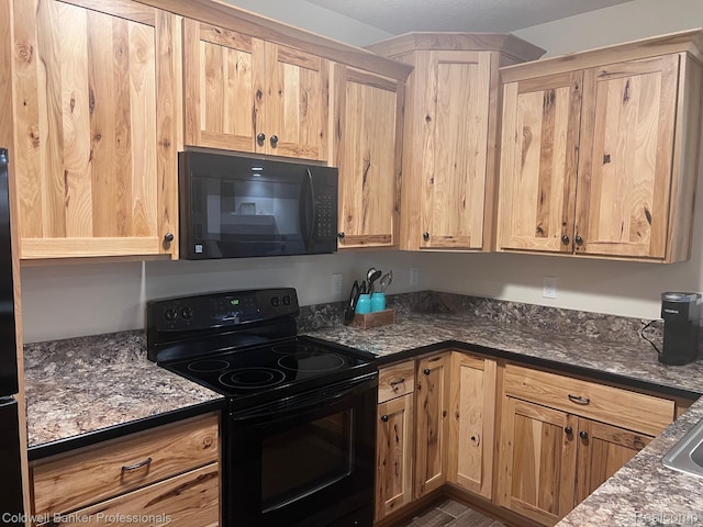 4264 W Benjamin Rd, Perry, MI 48872 - kitchen featuring black appliances, dark stone counters, and light brown cabinetry