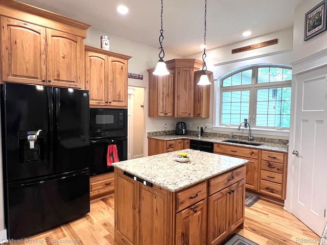 4264 W Benjamin Rd, Perry, MI 48872 - kitchen featuring black appliances, a sink, light wood-style flooring, light stone countertops, and recessed lighting