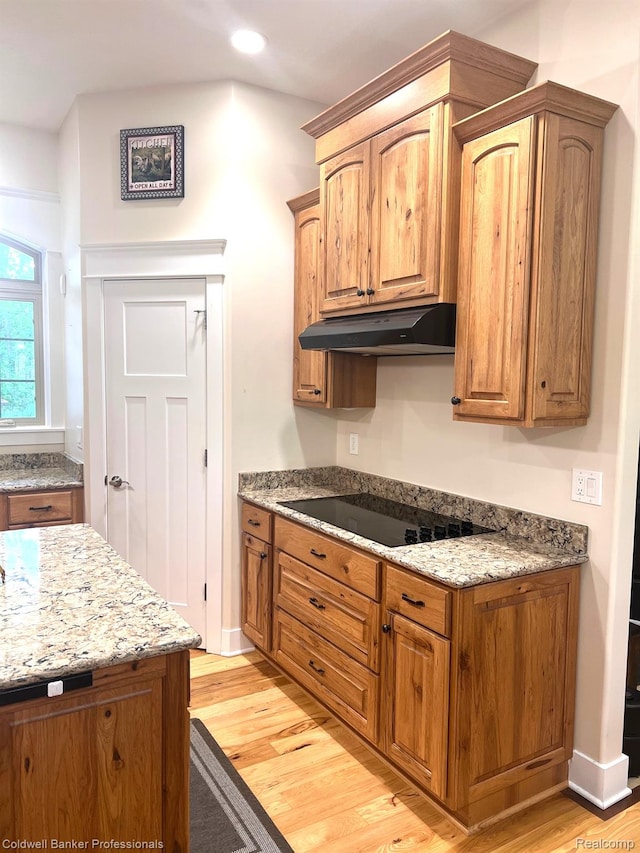 4264 W Benjamin Rd, Perry, MI 48872 - kitchen featuring under cabinet range hood, black electric cooktop, light wood-type flooring, light stone countertops, and recessed lighting