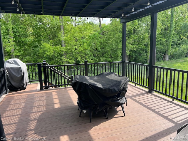 4264 W Benjamin Rd, Perry, MI 48872 - wooden terrace with grilling area and a forest view