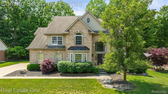 3788 High Grove Way, Lake Orion, MI 48360 - traditional-style home with a front yard, brick siding, and roof with shingles