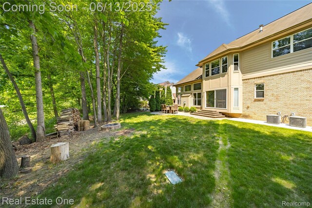 3788 High Grove Way, Lake Orion, MI 48360 - view of green lawn with cooling unit, a patio area, and entry steps
