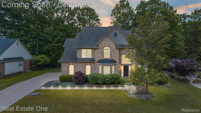 3788 High Grove Way, Lake Orion, MI 48360 - view of front facade featuring a yard, brick siding, concrete driveway, and roof with shingles
