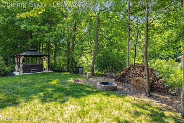 3788 High Grove Way, Lake Orion, MI 48360 - view of grassy yard with a hot tub, an outdoor fire pit, and a gazebo