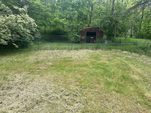342 Grand St, Michigan Center, MI 49254 - view of yard with an outdoor structure, a pole building, and a view of trees