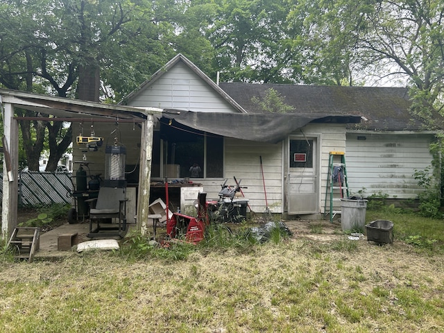 342 Grand St, Michigan Center, MI 49254 - rear view of property featuring roof with shingles and a yard