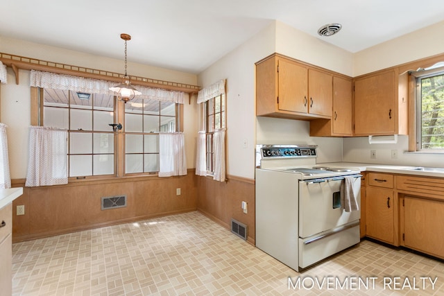 1001 Cricklewood St SW, Wyoming, MI 49509 - kitchen featuring white electric range, light countertops, and decorative light fixtures