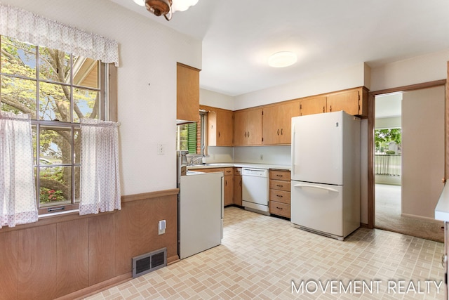 1001 Cricklewood St SW, Wyoming, MI 49509 - kitchen with white appliances, light countertops, brick patterned flooring, wainscoting, and wallpapered walls