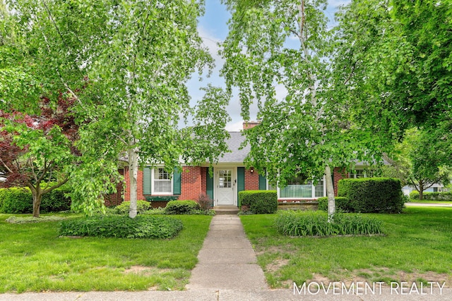 1001 Cricklewood St SW, Wyoming, MI 49509 - obstructed view of property featuring brick siding, a front lawn, and roof with shingles