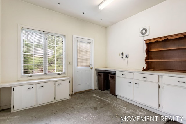 1001 Cricklewood St SW, Wyoming, MI 49509 - kitchen featuring white cabinets, light countertops, unfinished concrete floors, and open shelves