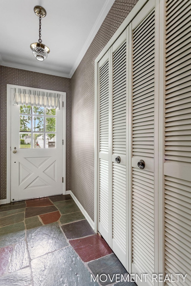 1001 Cricklewood St SW, Wyoming, MI 49509 - entryway featuring stone floors, crown molding, wallpapered walls, and baseboards
