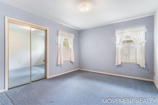 1001 Cricklewood St SW, Wyoming, MI 49509 - unfurnished bedroom with carpet, baseboards, and a closet