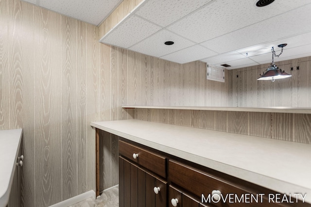 1001 Cricklewood St SW, Wyoming, MI 49509 - bar area with a drop ceiling, wooden walls, and pendant lighting
