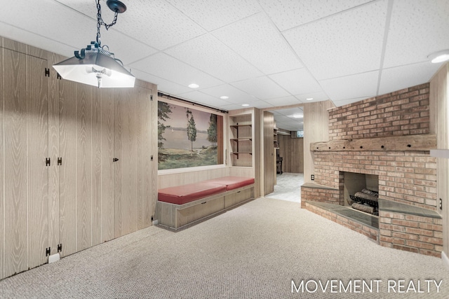 1001 Cricklewood St SW, Wyoming, MI 49509 - bathroom featuring wooden walls, a brick fireplace, and a paneled ceiling