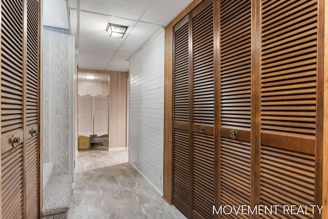 1001 Cricklewood St SW, Wyoming, MI 49509 - corridor with a drop ceiling, wood walls, and a heating unit