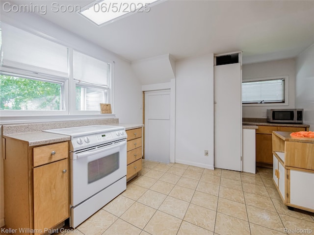 227 Ora Rd, Oxford, MI 48371 - kitchen featuring stainless steel microwave, white range with electric cooktop, light countertops, and light tile patterned floors