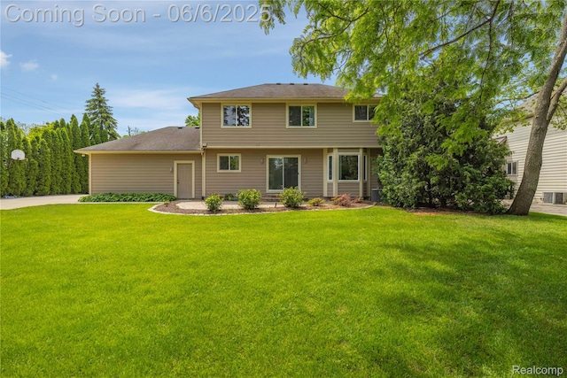 2105 Rob Rdg, Commerce Twp, MI 48390 - rear view of property with a yard