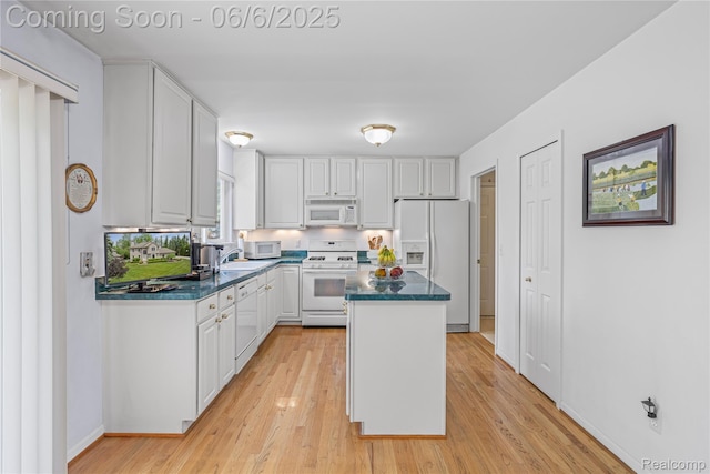 2105 Rob Rdg, Commerce Twp, MI 48390 - kitchen featuring white appliances, white cabinetry, a center island, dark countertops, and light wood-type flooring