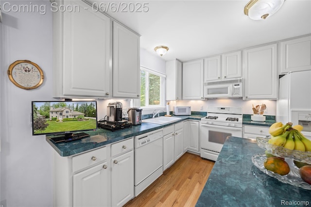 2105 Rob Rdg, Commerce Twp, MI 48390 - kitchen featuring white appliances, a sink, and white cabinetry