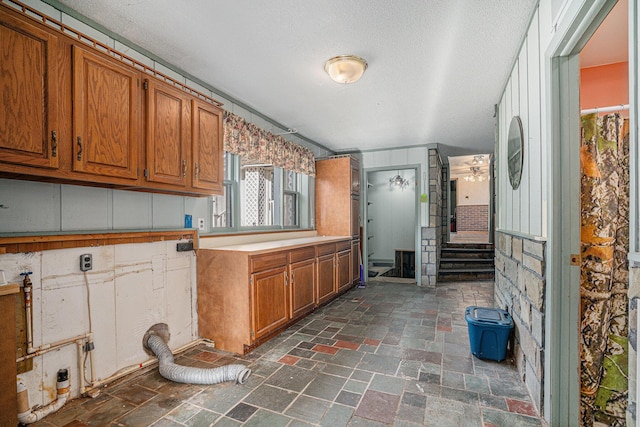 19146 Fairchild Rd, Constantine, MI 49042 - kitchen featuring brown cabinets, a textured ceiling, and light countertops