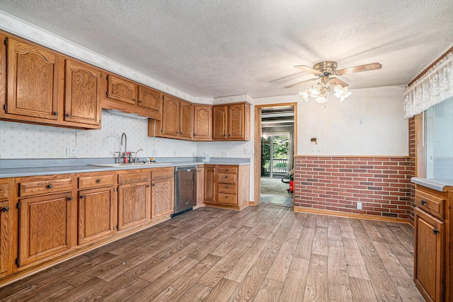 19146 Fairchild Rd, Constantine, MI 49042 - kitchen featuring a sink, dishwasher, a textured ceiling, wood finished floors, and a ceiling fan