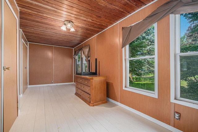 19146 Fairchild Rd, Constantine, MI 49042 - spare room featuring wooden ceiling, plenty of natural light, wooden walls, and light wood-style flooring
