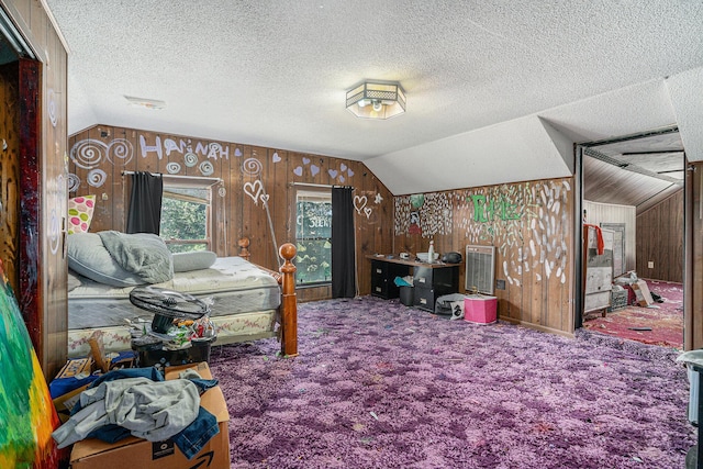 19146 Fairchild Rd, Constantine, MI 49042 - bedroom featuring lofted ceiling, carpet floors, wood walls, and a textured ceiling