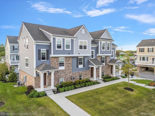 4953 Treeside Ln, Troy, MI 48098 - view of front of house featuring stone siding, a front yard, and a shingled roof