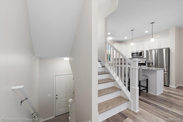 4953 Treeside Ln, Troy, MI 48098 - stairway with recessed lighting and wood finished floors