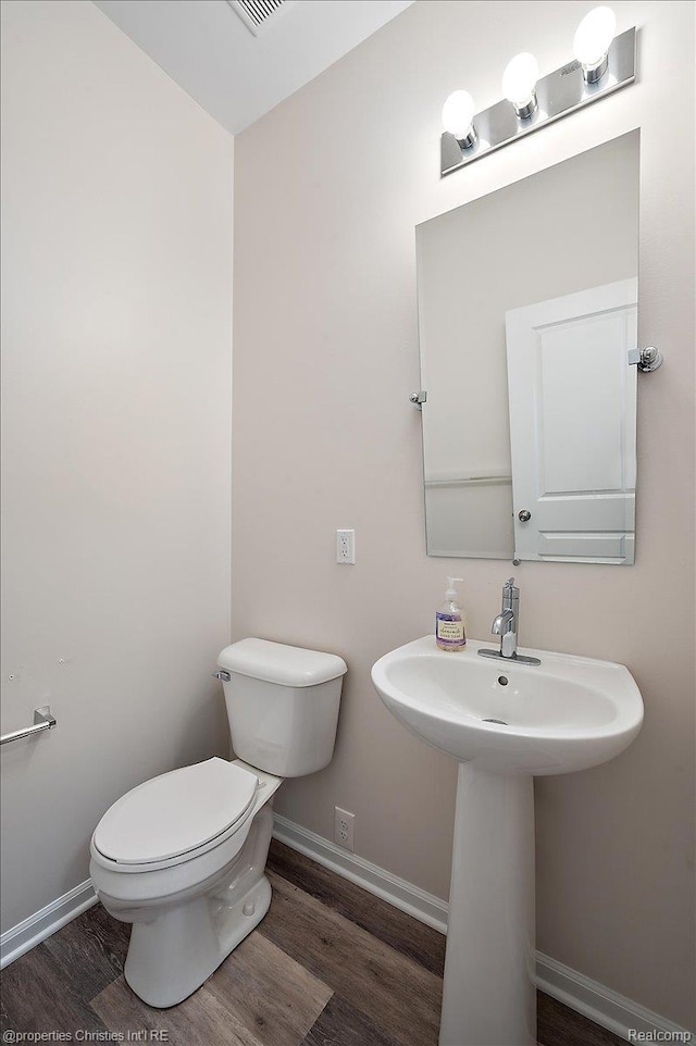 4953 Treeside Ln, Troy, MI 48098 - half bathroom featuring toilet and wood finished floors